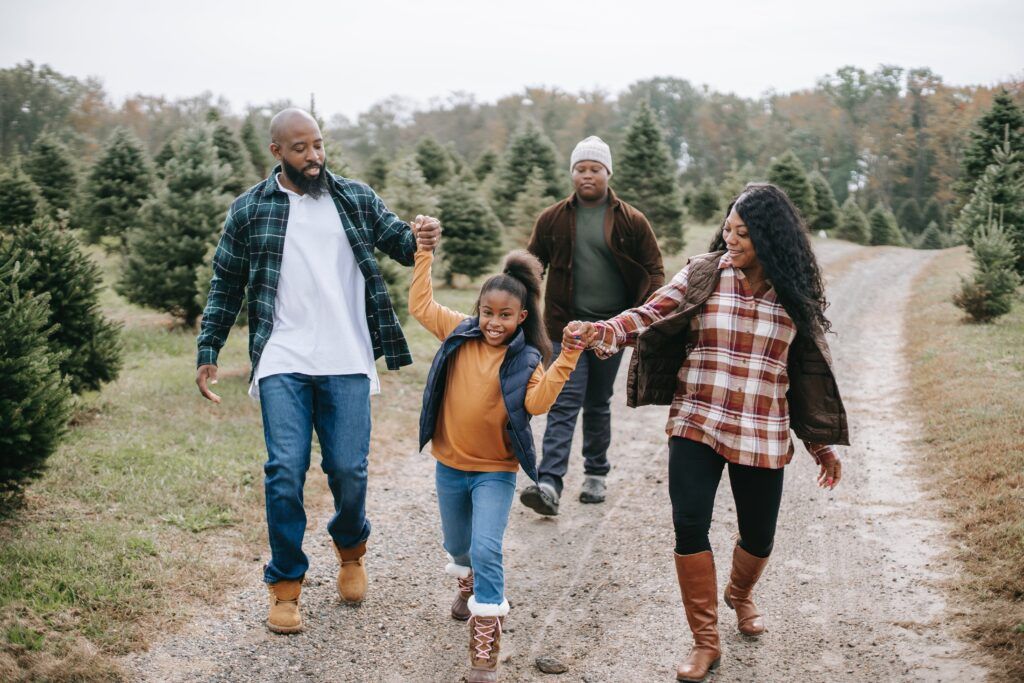 Family walking on a tree farm.