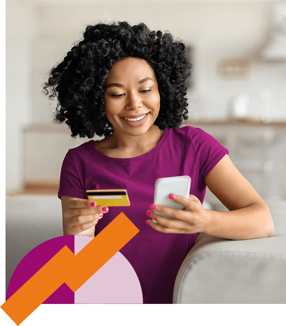 Woman looking at phone and paying mobile bill with credit card