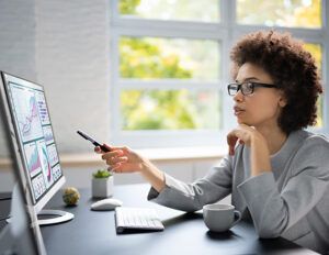 Woman pointing at computer screen