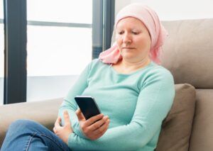 Cancer patient looking at mobile phone