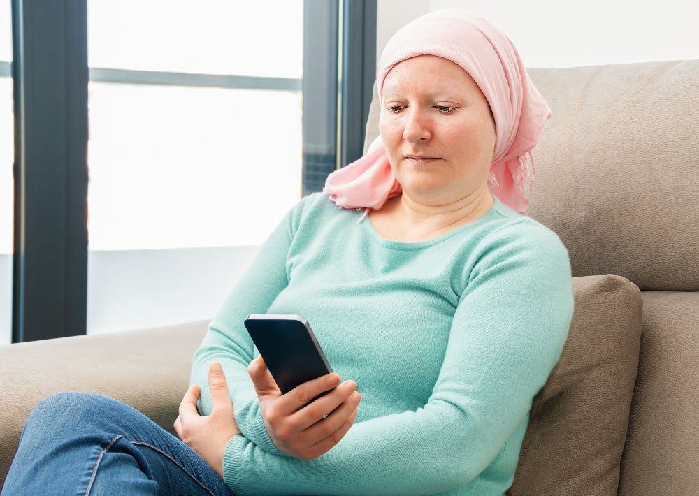Cancer patient looking at mobile phone